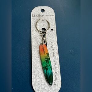 Kauai Surfboard Keychain with sunset & palm trees in green and orange. Flexible